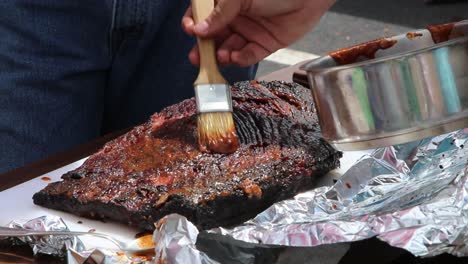 Basting-a-fully-cooked-brisket-to-keep-it-moist-and-add-flavor-to-the-bark