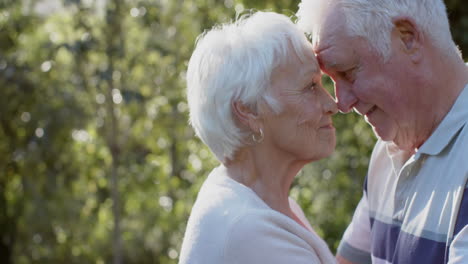 Happy-senior-caucasian-couple-embracing-in-sunny-garden,-slow-motion,-copy-space