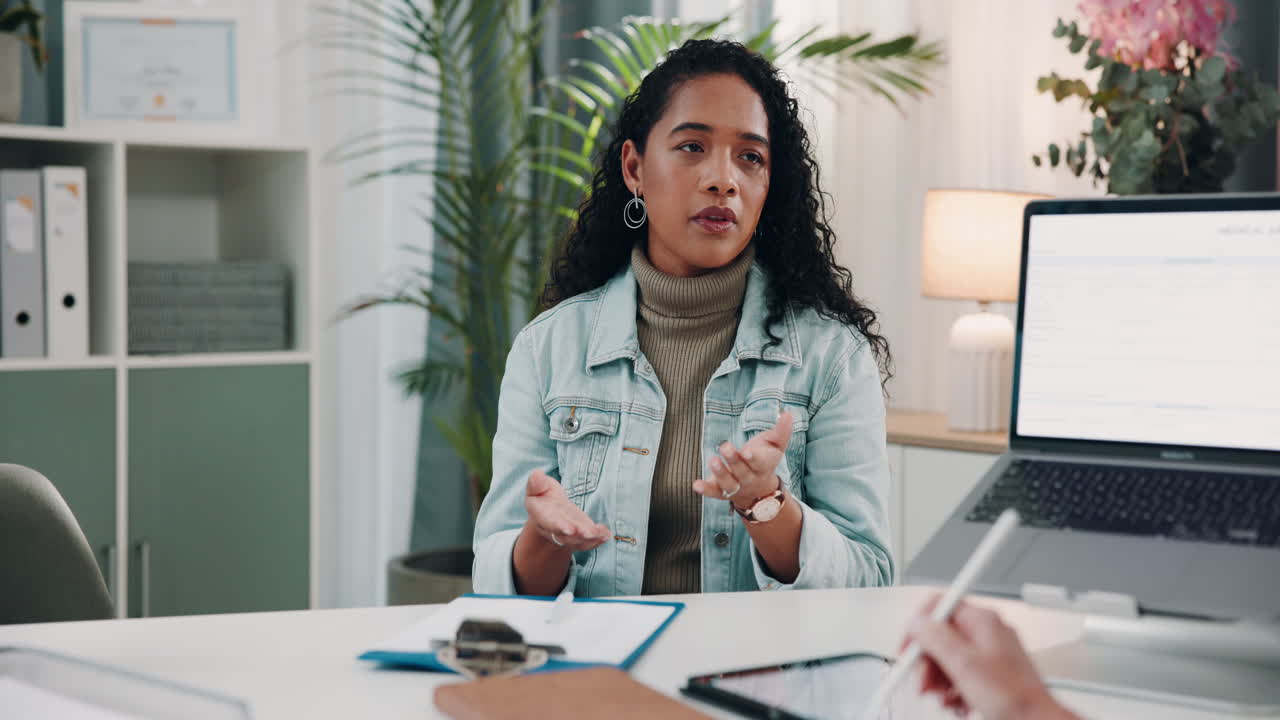 Woman Describing Shoulder Pain to Doctor