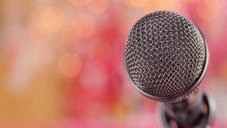 microphone on stage against a blurry light ,blurry background.