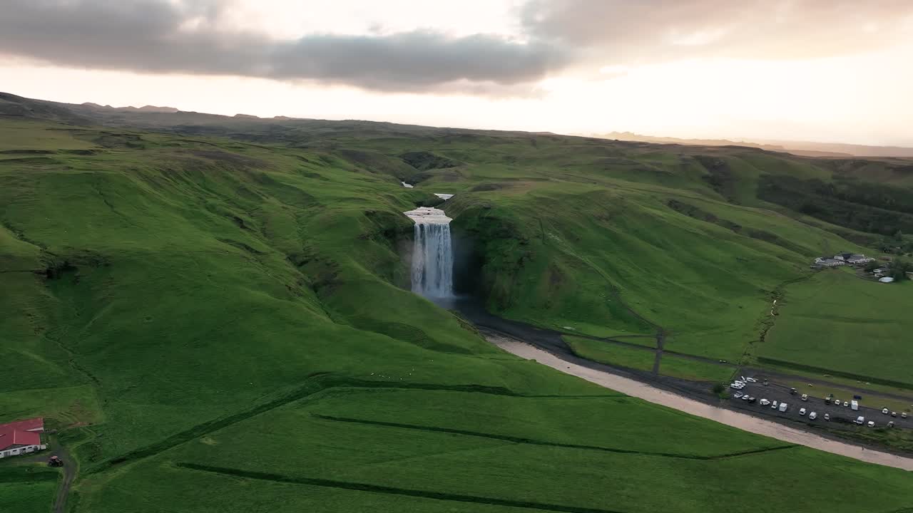 Sk&oacute;gafoss, South Iceland - A Tranquil View of Botanicals and Streaming Waterfall - Aerial Sideways