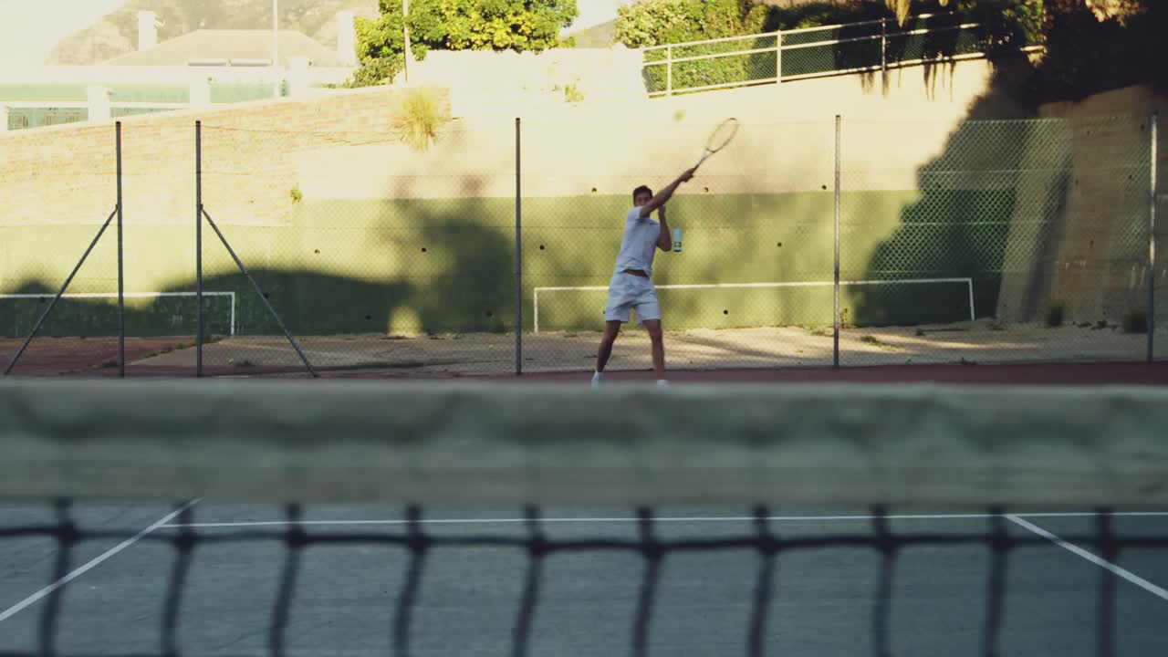 Man playing tennis on a sunny day