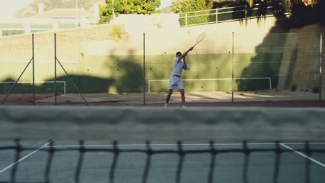 man playing tennis on a sunny day