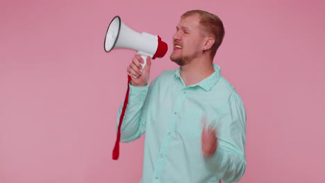 smiling bearded man talking with megaphone, proclaiming news, loudly announcing sale advertisement