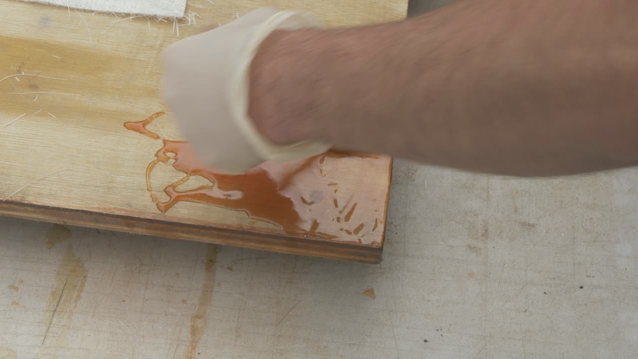 Brushing out Polyester resin over Plywood for fiberglass