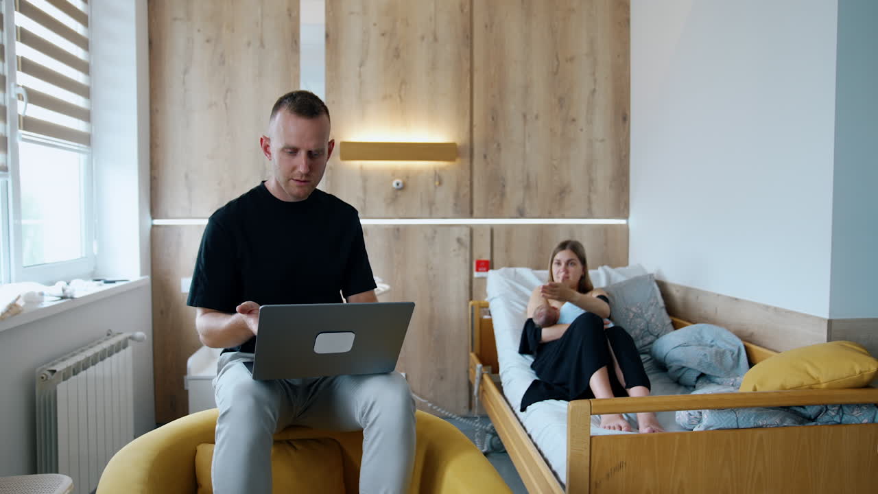 Married couple arguing about laptop usage. Man is focused on work while woman has to take care of baby.