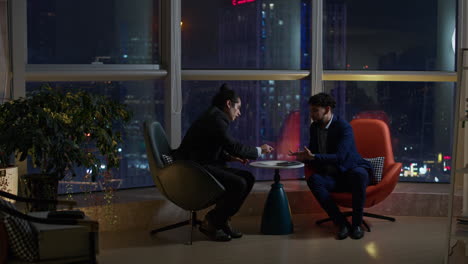 business meeting at night with city view