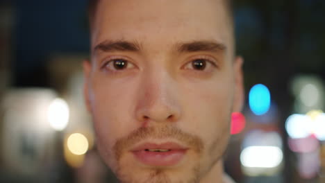 close-up portrait of a man at night in a city