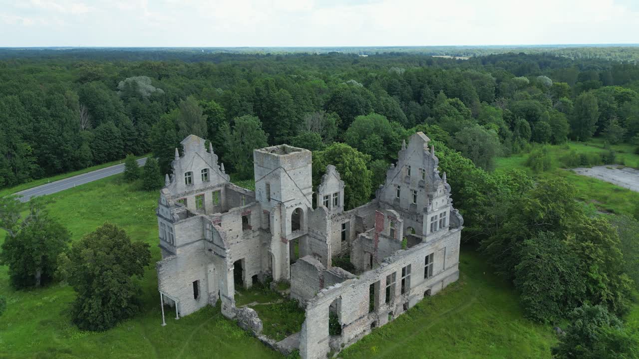 Aerial pulls out from stone wall ruins of Ungru Castle in Estonia