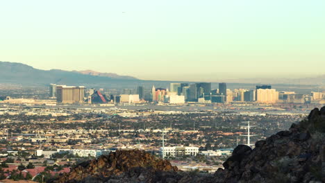 las vegas strip skyline revealed from a rocky desert mountain, aerial