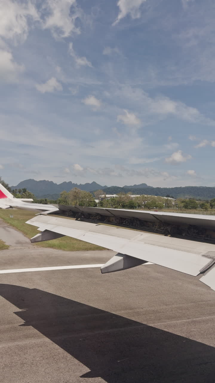 view from a plane window of the sky with the wing shot in vertical