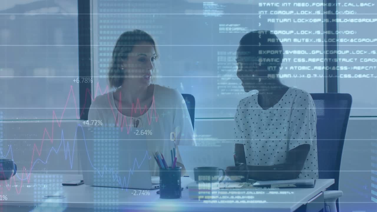 Office woman gesturing at laptop showing finance overlay charts while colleague raising hand