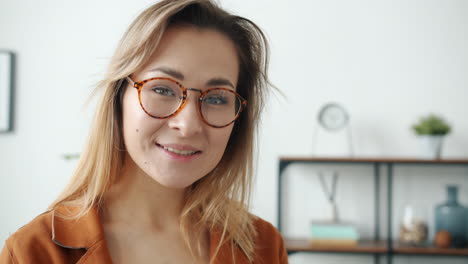 woman with glasses smiling