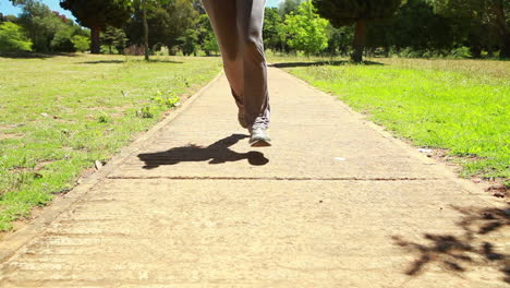 a low angle video of a woman running down towards the camera