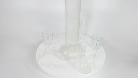 beakers rotating on a white platform