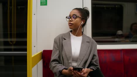 woman using smartphone on subway