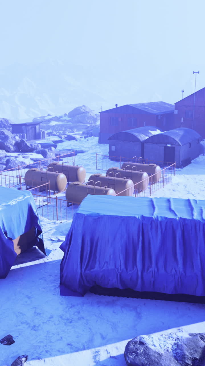 Winter landscape showcasing remote mountain camp under a blue sky