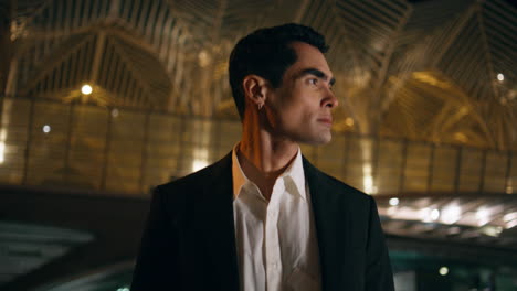 business man walking night city closeup. elegant manager looking asides crossing