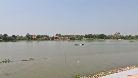 boats moving across a calm river landscape