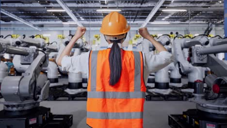 ingeniero observando robots en una fábrica