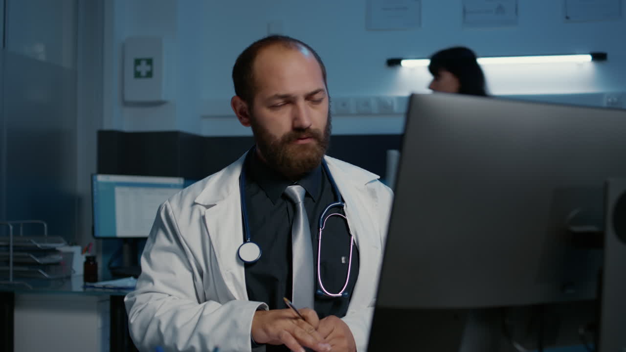 Tired doctor working late in the office