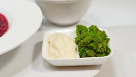 Borscht with Cream and Green Sauce