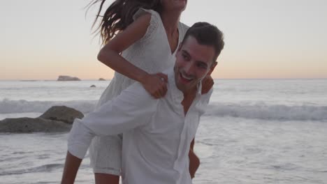 Young-adult-couple-relaxing-at-the-seaside