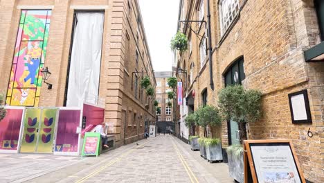 empty alley with colorful storefronts and plants