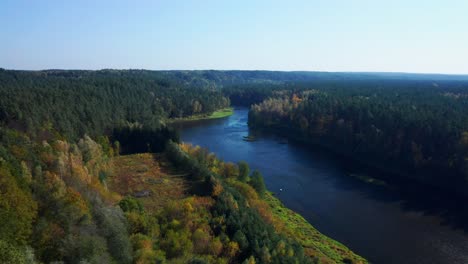 Flying-Over-Wooded-Landscape-With-Autumnal-Tree-Foliage-Of-Neris-Regional-Park-In-Lithuania