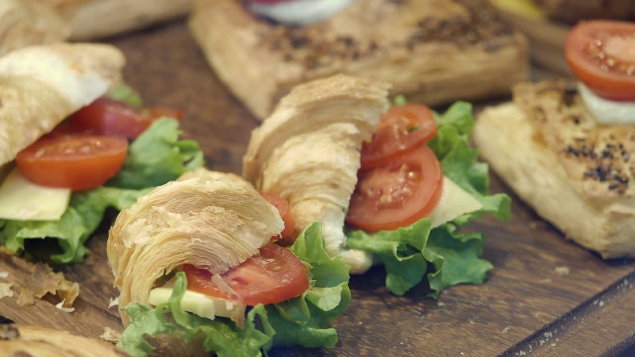 Croissant sandwiches with tomato, lettuce, and cheese