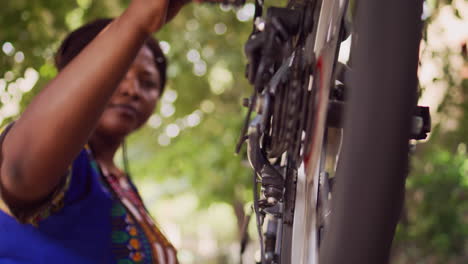 female checking bicycle performance