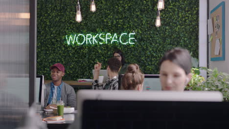 young group of business people working team leader woman training intern pointing at computer screen sharing ideas showing support colleagues collaborating in diverse modern office