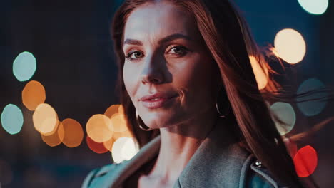 close-up portrait of a woman at night with city lights bokeh