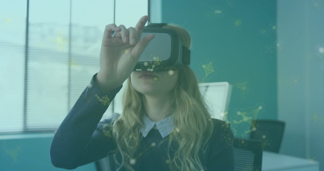 woman in VR headset raising hand pinching and rotating graphics appearing around for tech analysis