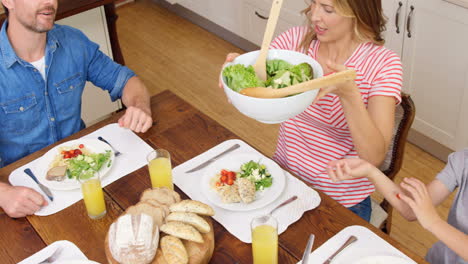 Family-having-dinner-together-in-kitchen