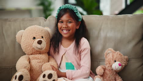 girl with teddy bears on sofa