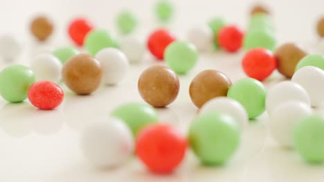 colorful round candies on white reflective surface 4k