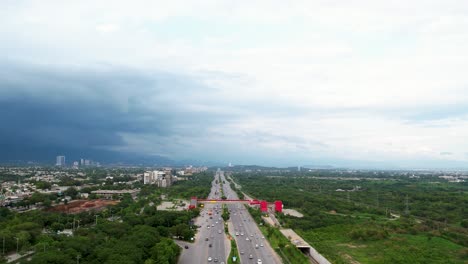 Islamabad-Aerial-View---Amazing-drone-shot-of-Kashmir-highway-in-Islamabad-Capital-of-Pakistan,-busy-traffic-roads-and-bridges-during-the-daytime