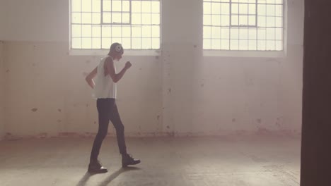 fashionable young man in an abandoned warehouse