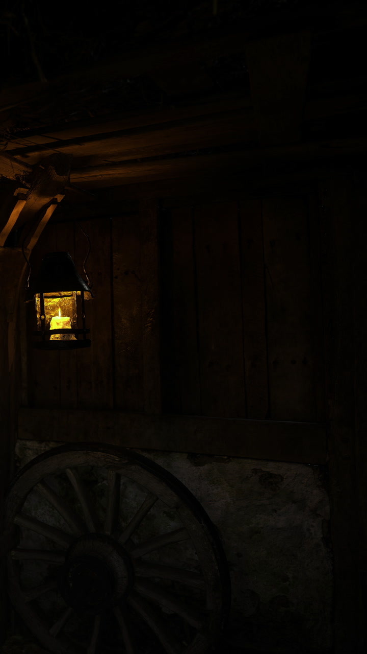 Warm glow of a rustic lantern illuminating the dark wooden cabin