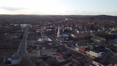Sweeping-view-of-Hudson,-Massachusetts-town-center-at-sunset-during-winter