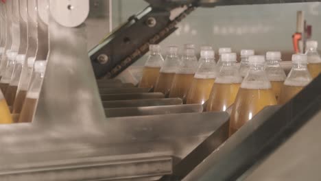 conveyor belt with bottles for juice or water at a modern beverage plant. modern production of sweet soda water