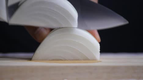 the chef uses a kitchen knife to cut the onions