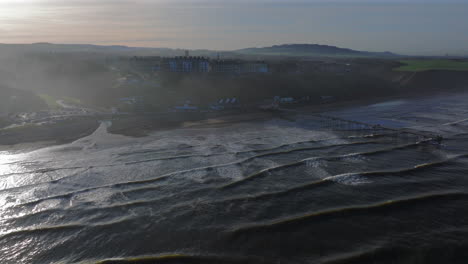 Establishing-Drone-Shot-of-Saltburn-by-the-Sea-over-Sea-at-High-Tide