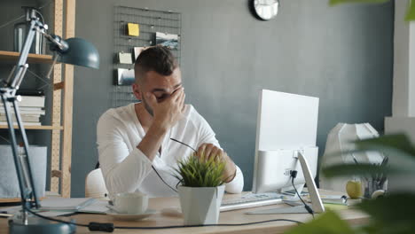 man working at a computer in a modern office