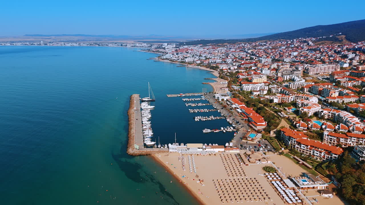 Beautiful resort area on the mountain slope. Flight over the yacht club and sandy beach of Sveti Vlas, Bulgaria from drone