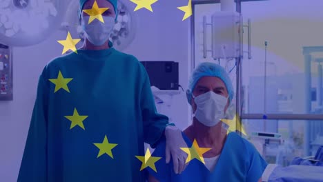 Animation-of-flag-of-european-union-over-caucasian-female-and-male-surgeons-in-face-mask