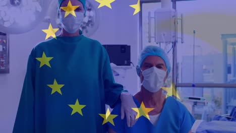 animation of flag of european union over caucasian female and male surgeons in face mask