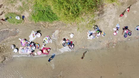 Haitian-People-Doing-The-Laundry-By-The-Dajabon-River,-Also-Called-Massacre-River-In-The-Dominican-Republic