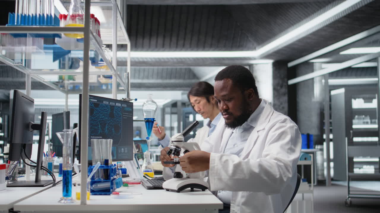 Vertical video Chemical engineer using microscope to evaluate test specimens in lab